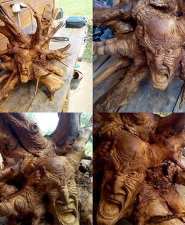 The head is carved from the root of a tree by "Carved Madness"